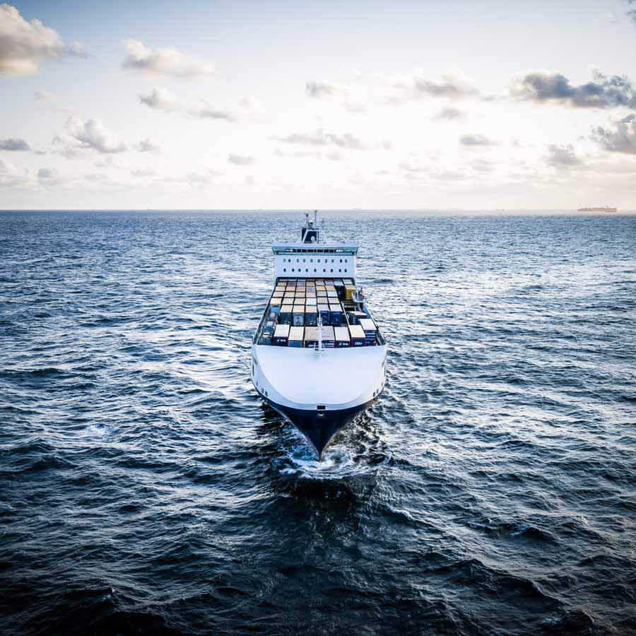 theblackdrone GmbH DFDS Container Ship . Open Sea . Primula Seaways . Aerials. Horizon . Sunset.